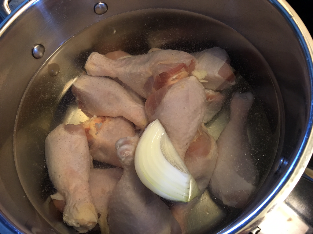 Boil chicken and 1/4 onion